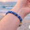 Hand braided Kumihimo bracelet worn at the beach at sunset, blue and aqua glass seed bead bracelet, coastal style jewelry